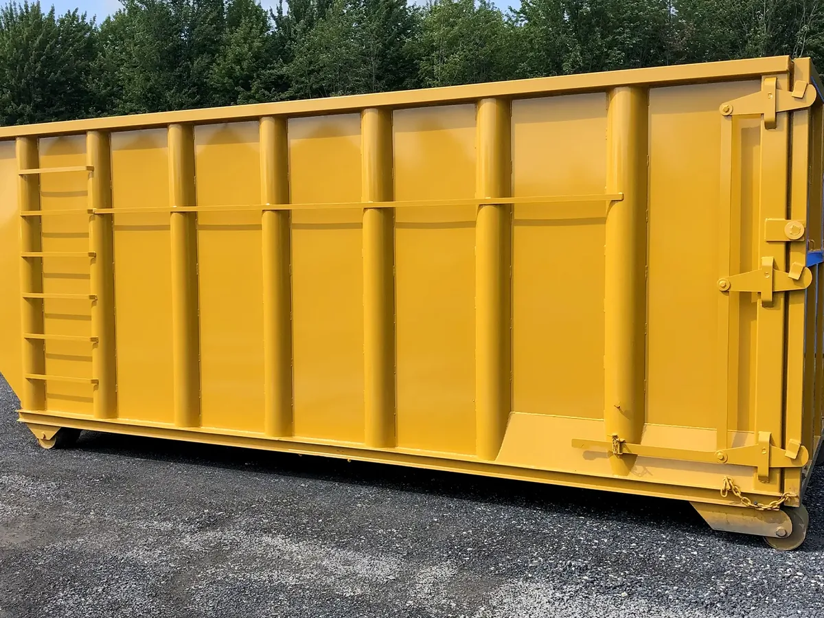 Tall yellow roll-off dumpster with a side ladder on a gravel lot, 40 yard dumpster rental