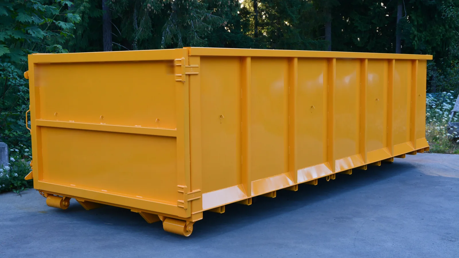 Yellow roll-off dumpster on a paved lot, roll-off dumpster rental